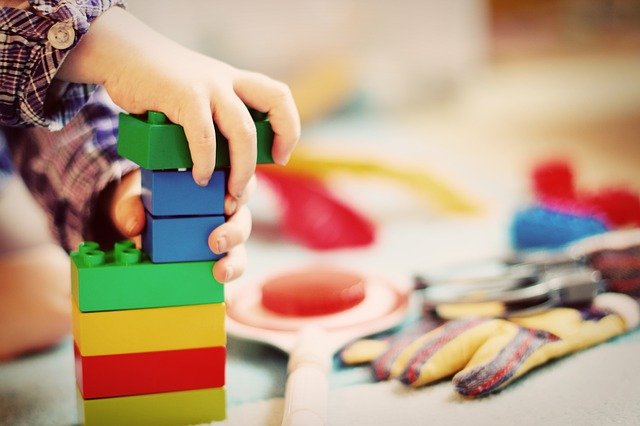 child stacking legos